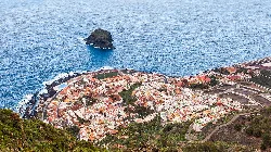 Aerial view of Garachico with buildings, coast, and sea in Tenerife.