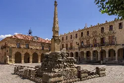 Fountain in Soria's Main Square with historic buildings.