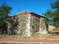 Humilladero hermitage in Bernardos, rear view with stone walls and tiled roof.