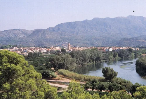 Landscape with river, trees, and mountains in Xerta.