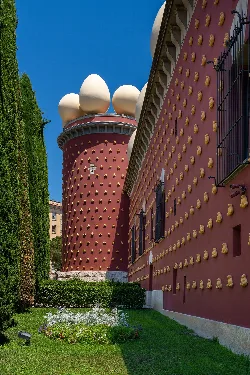 Facade of the Dalí Theatre-Museum in Figueras with colorful details and surreal shapes.