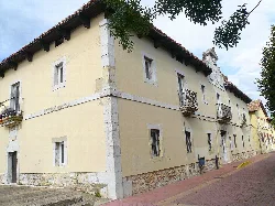 Yellow building with iron balconies in Guardo.