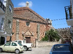 Brick church facade with architectural details in Galisteo.