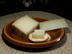 Zamorano cheese on a plate with different cuts and a cracker.