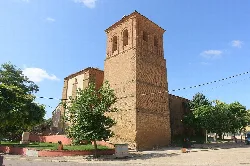 Brick tower of the church and trees in La Unión de Campos.