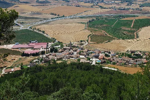 Aerial view of a village with fields and forests in Navarra.