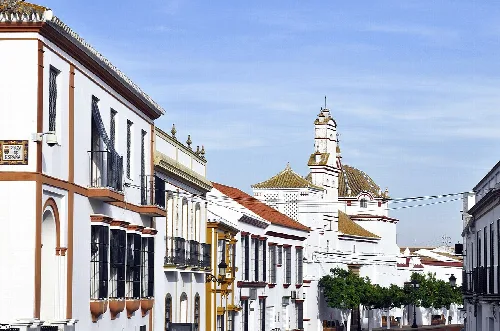 Houses at Francisco Alcalá Ave.; in the background, St. John the baptist monastery. Villalba del Alcor, Huelva, Andalusia, Spain