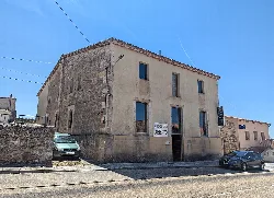 Stone building in Pereruela with a sign for an open museum.