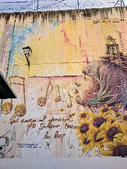 Mural with a woman, sunflowers, and musical notes in Villangómez, Burgos.