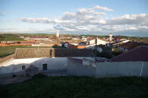 View of houses and buildings in a town with cloudy sky.