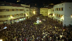 Large crowd on a street in Andorra during a Holy Week procession.