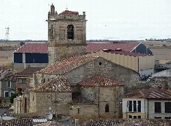 Church of Santiago Apóstol with tower and red roofs in Villalba de los Alcores.