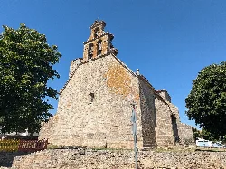 Church of San Juan Bautista with tower and stone facade in Almeida de Sayago.