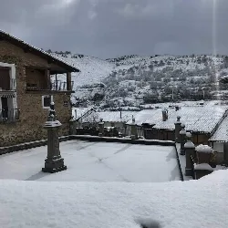 Snow-covered Plaza Don Simón with snowy mountains in the background.