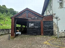 Museum entrance with wooden structure and sign that says Sagardoetxea.