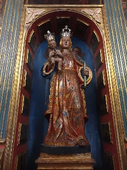 Statue of the Virgin of Candelaria holding the child, in a decorated niche.