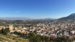 Vista panorámica de Jódar con montañas y campos en el fondo.