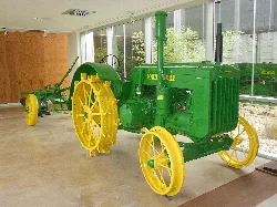 Old John Deere tractor on display in a museum.