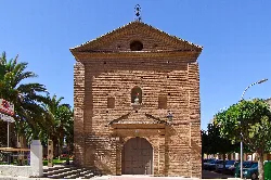 Brick chapel facade with door and bell tower in Alfaro.