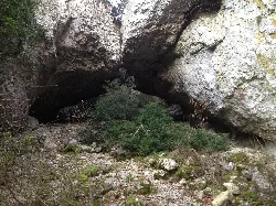 Ein natürlicher Felsdurchbruch bildet eine kleine Bogen über eine Schlucht.