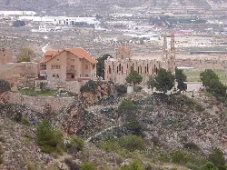 Santa María Magdalena sanctuary on a hill with trees and buildings.