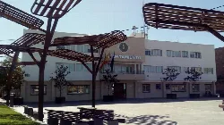 Armilla town hall building with benches and trees in the square.