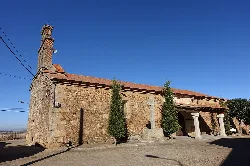 Iglesia de piedra con columnas en la entrada y árboles delante en Sepulcro-Hilario.