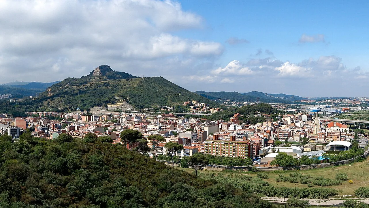 Panoramic view of Montcada i Reixac with mountains and city in the background.