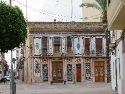 Facade of a modernist house with tiles and artistic details in Almassera.