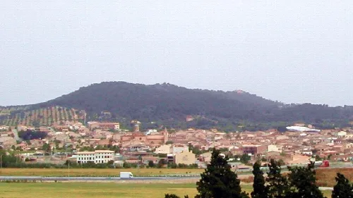 View of a town with green hills in the background in the Balearic Islands