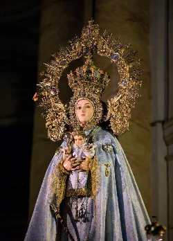 Statue of Our Lady of Bethlehem with crown and attire inside a church.
