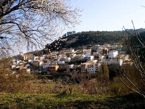 View of white houses on a mountain slope from a nearby hill.