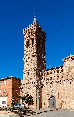 Brick tower with geometric patterns at Herrera de los Navarros church.