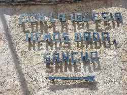 Inscription on a church wall in El Toboso that says: 'With the church we have given, Sancho'.