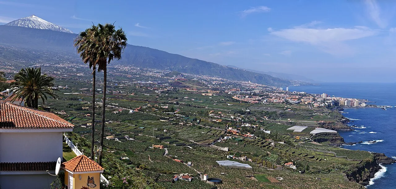View of the valley with mountains, towns, and Mount Teide in the background.