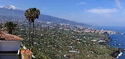 View of the valley with mountains, towns, and Mount Teide in the background.