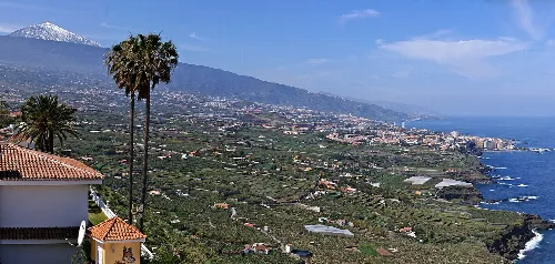 View of the valley with mountains, towns, and Mount Teide in the background.