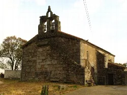 Stone church with bell tower and stairs in Valdehijaderos, Salamanca.