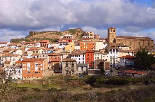 Urban landscape of Nalda with houses and a church on the hill.