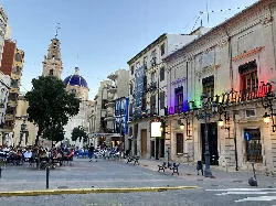 Sueca town square with cafes and historic buildings on a summer afternoon.