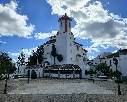 White church with tower in Alozaina, Málaga.
