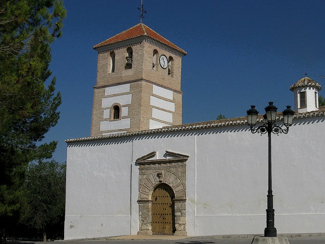 Church with tower and clock in Cortes de Baza, Granada, Spain.