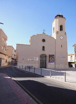 White church with tower and clock in Rafal, Alicante.