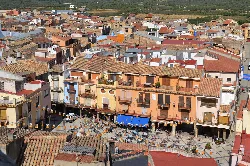 Aerial view of the square with buildings and terraces in Sant Mateu.