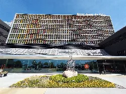 Sant Joan de Déu hospital building with sculpture in front garden.