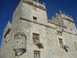 View of the stone tower with windows and a turret in Sant Mateu.