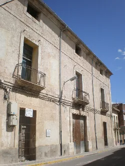 Stone building with iron balconies in Ollería.