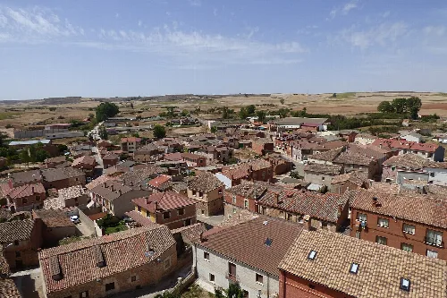 Aerial view of Santa María del Campo with rooftops and rural landscape in the background.