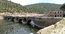 Stone bridge with arches over the Tajo river in Monfragüe.