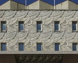 Facade of Giner Theatre with windows and relief details.